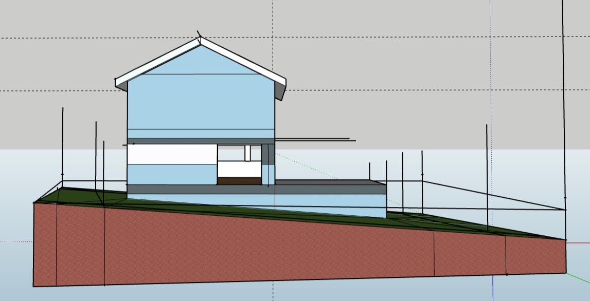 Architektenmodell eines zweigeschossigen blauen Hauses auf geneigtem Gelände.