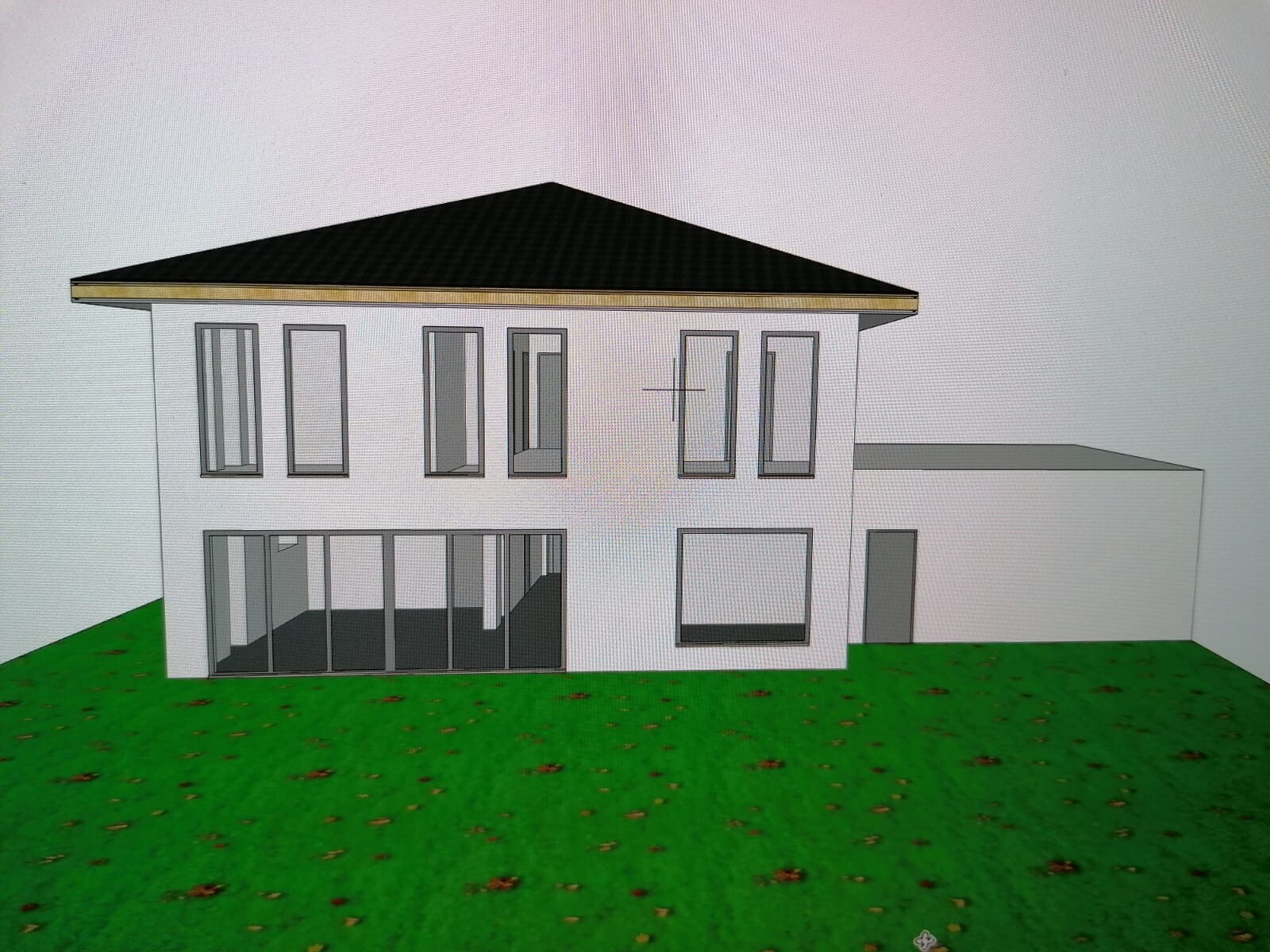 Moderne zweigeschossige Hausansicht mit großen Glasfronten, Flachdach und grünem Garten.