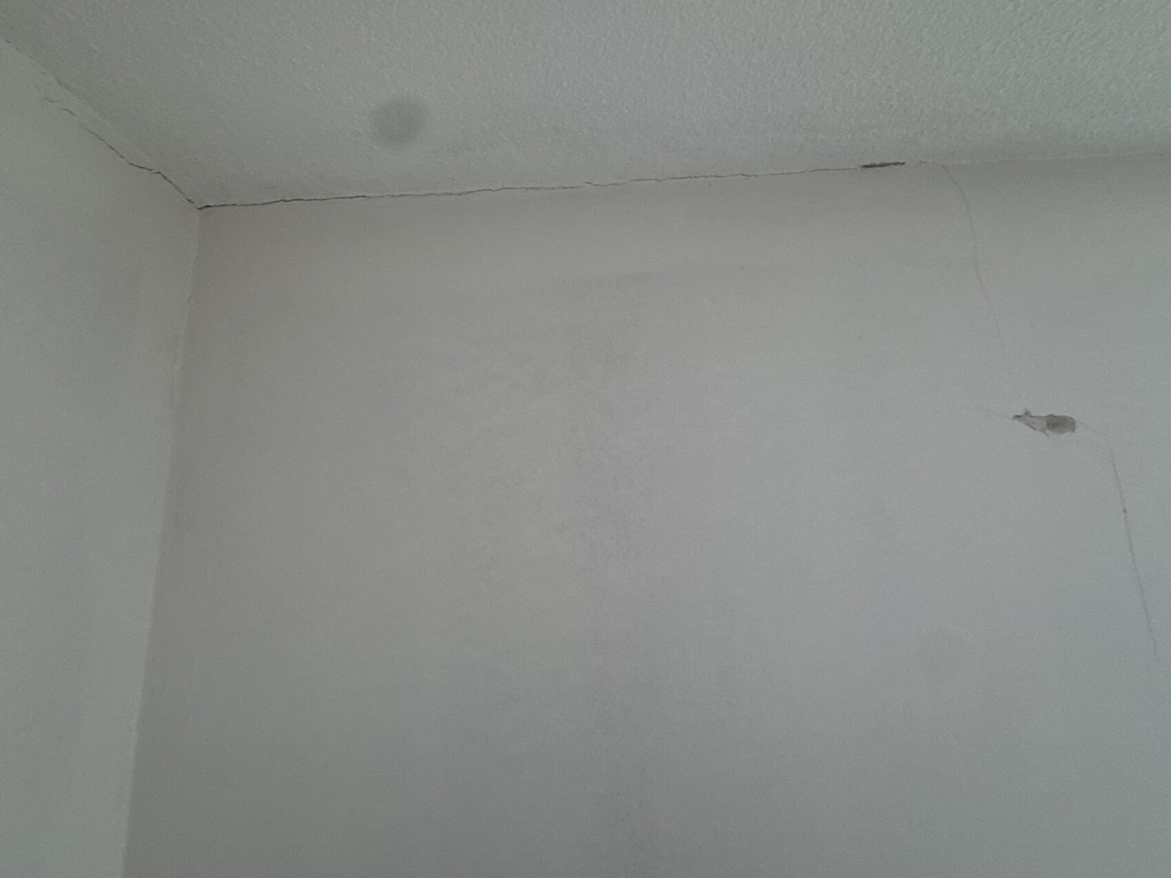 Eckwand mit Rissen im Putz, Anzeichen von Baumängeln an Innenwand
