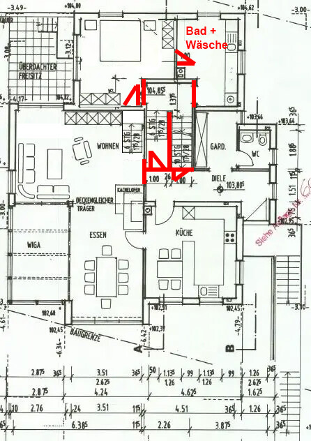 Grundriss eines Hauses mit Wohn-, Ess- und Küchenbereich; rote Markierungen zeigen Bad + Wäsche.