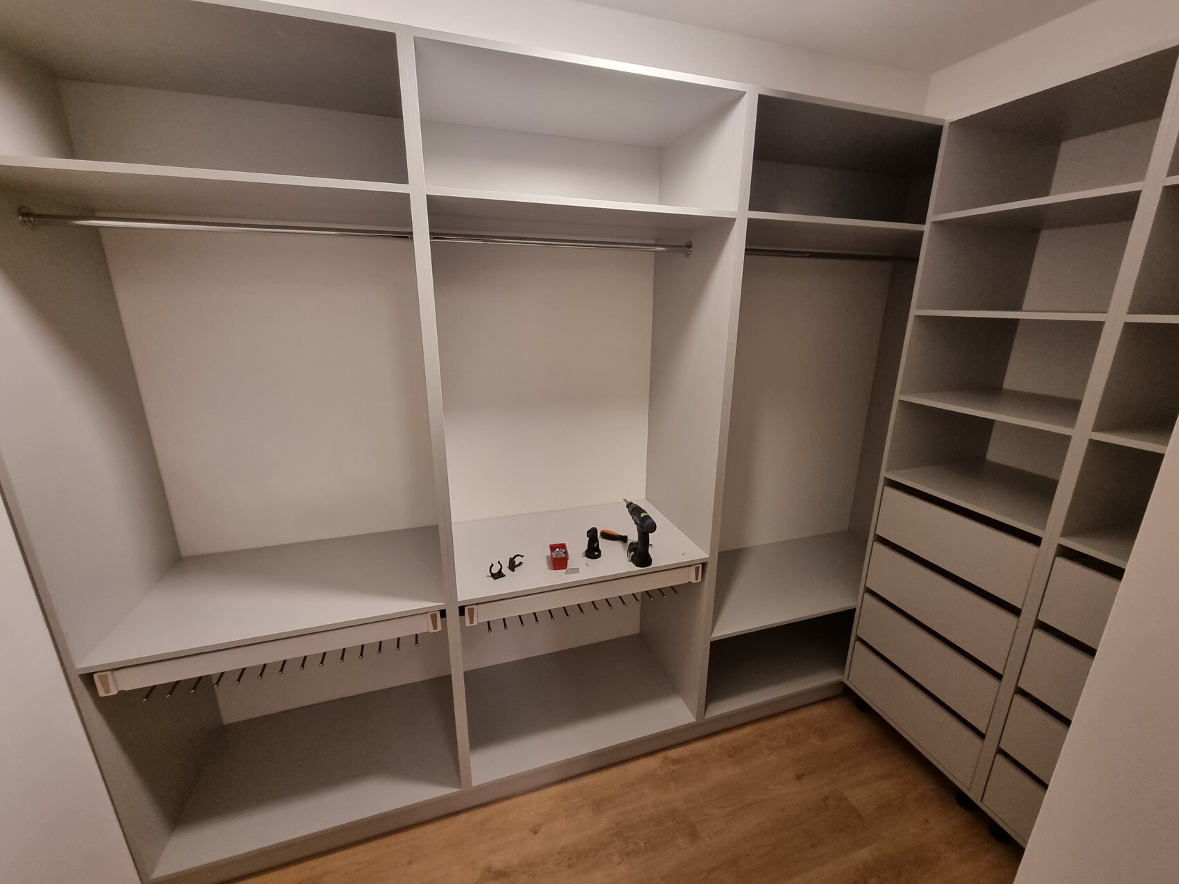 Weißer begehbarer Kleiderschrank mit Regalen, Kleiderstangen und Schubladen