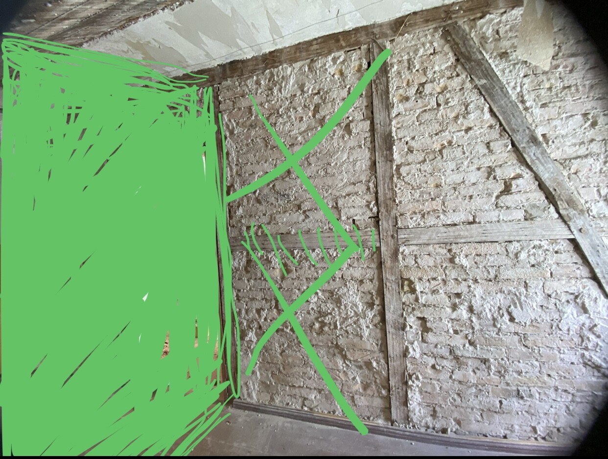 Dachboden mit Ziegelwand, Holzbalken und diagonaler Stütze; linke Fläche grün markiert