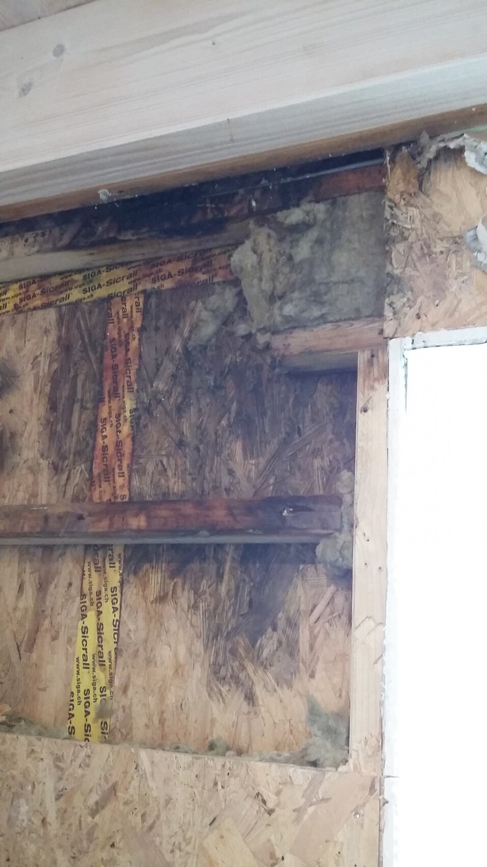 Rohbau Innenbereich mit OSB-Platten Dämmung und Holzbalken sichtbar
