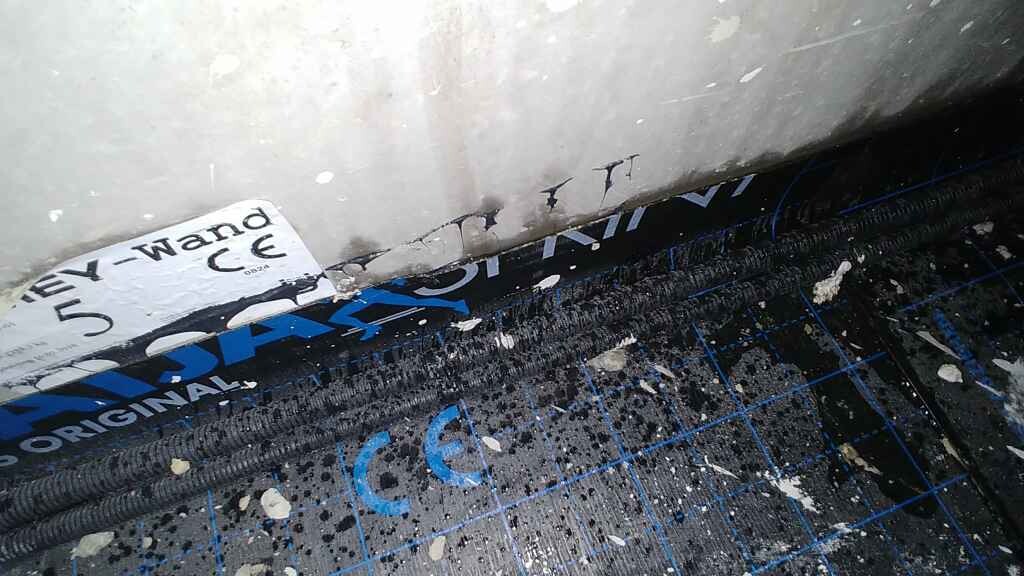 Innenbereich einer Baukonstruktion mit Daemmung und Feuchtigkeitsschutzbahn am Boden.