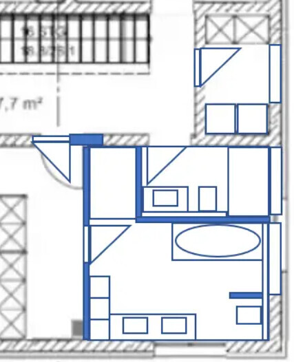 Grundriss eines Wohnungsplans in Blau: Eingangsbereich, Küche, Bad mit Badewanne und weitere Räume.