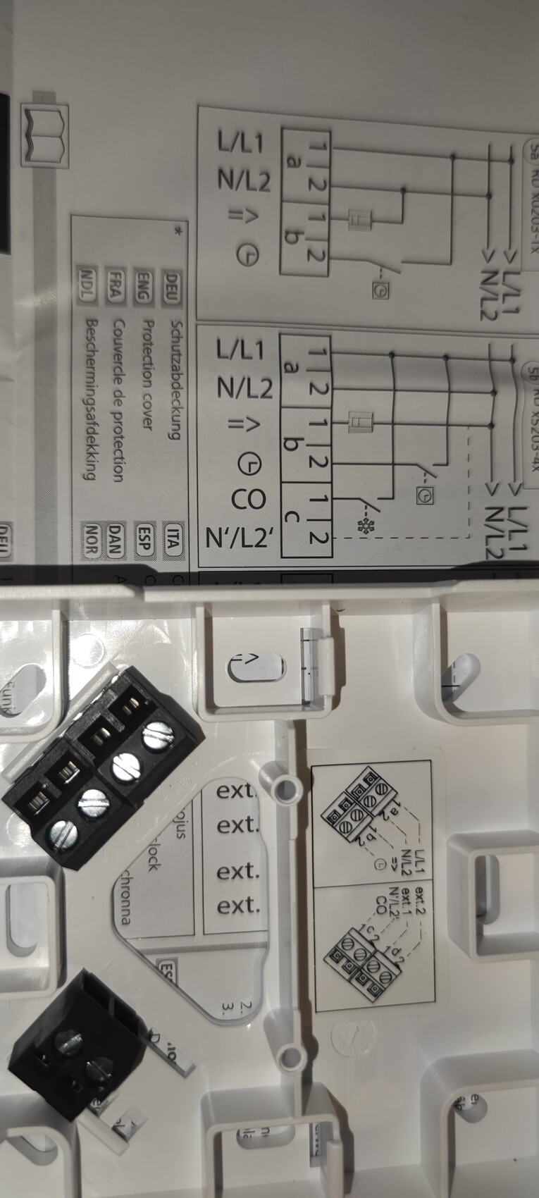Nahaufnahme eines elektrischen Schalters mit Verdrahtungsschema und Klemmenblock.