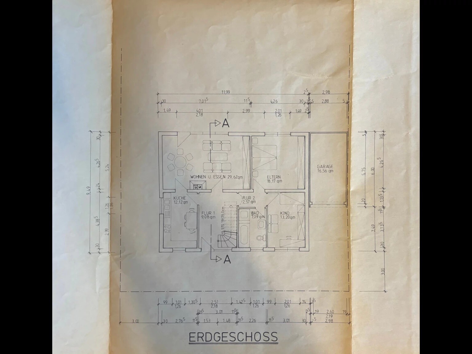 Grundriss Erdgeschoss mit Küche, Wohn-/Essbereich, Eltern- und Kinderzimmer, Bad, Flur, Garage.