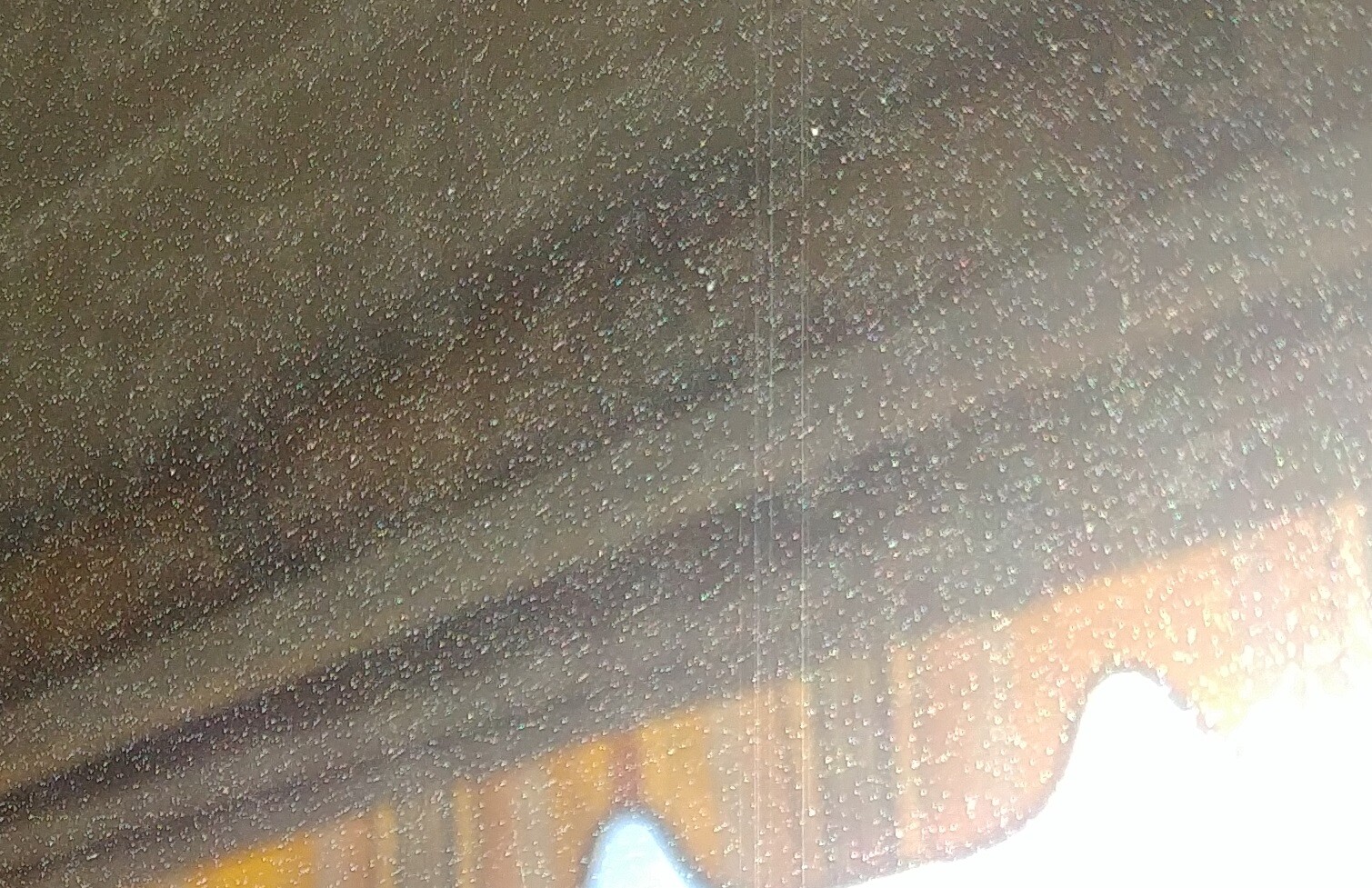 Nahaufnahme einer Fensterscheibe mit vielen Wassertropfen und Holzrahmen
