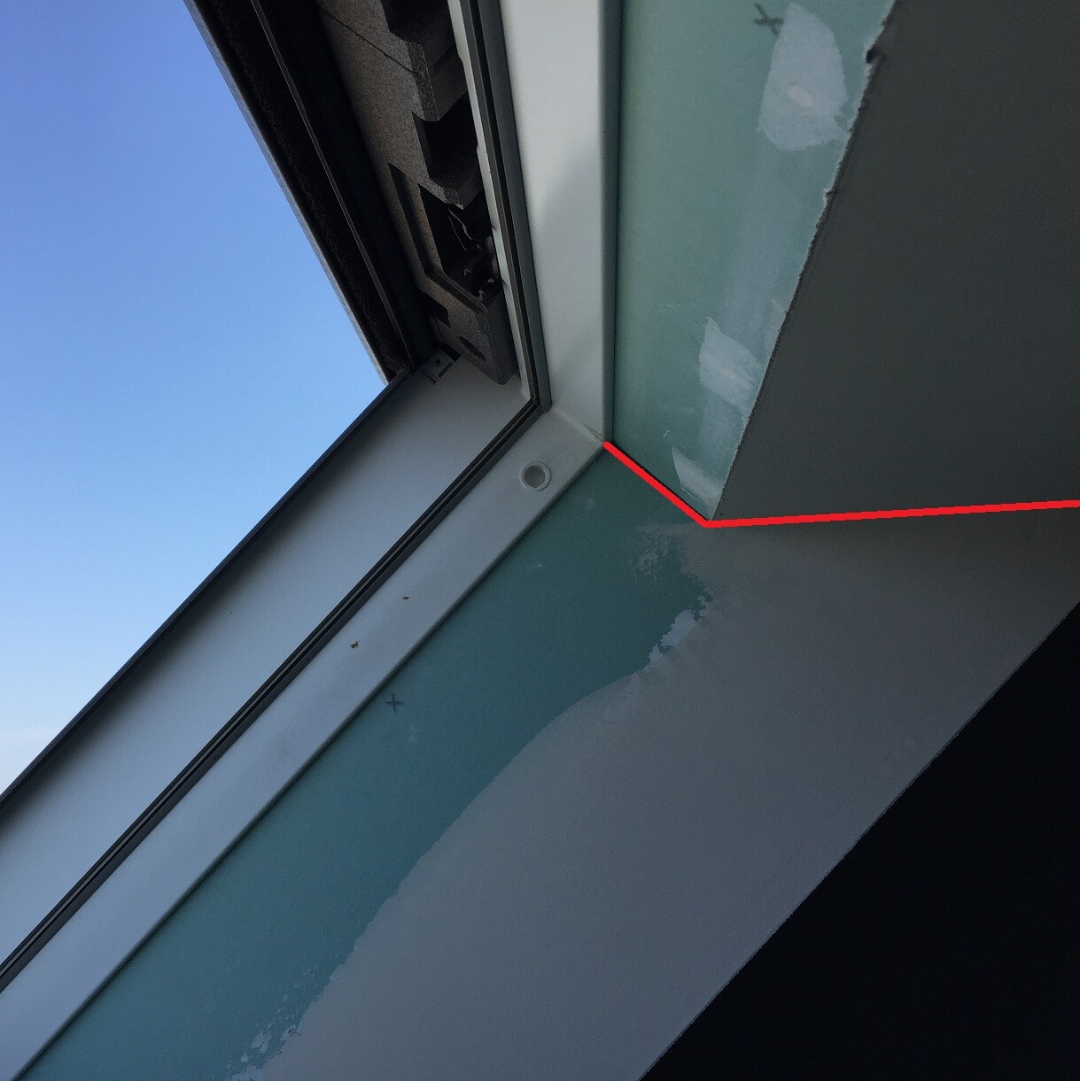 Nahaufnahme Fensterrahmen mit offener Dichtung und defekter Fuge, roter Marker zeigt Problem
