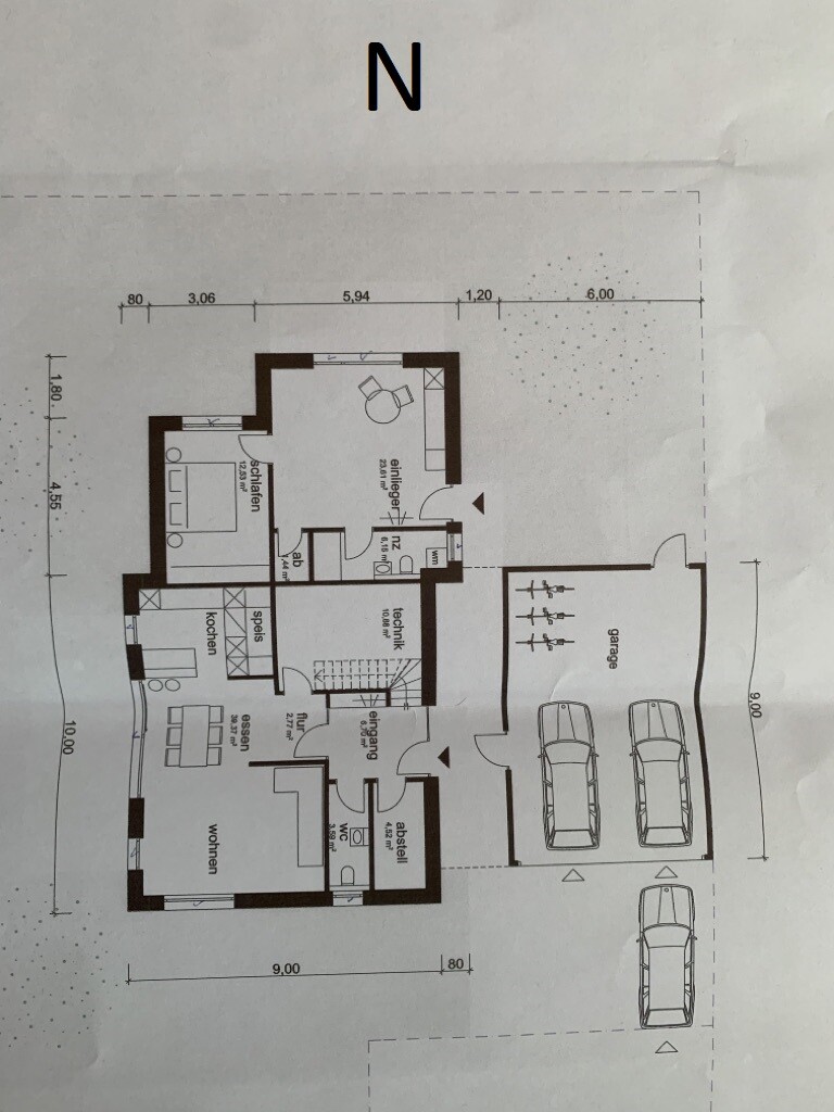 Grundriss eines Hauses mit Wohnzimmer, Küche, Bad, Flur, Abstellraum und Garage