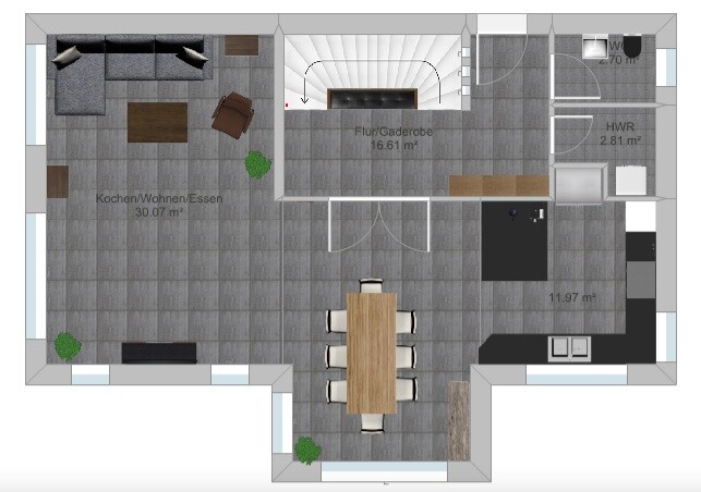 Offener Grundriss: Küche/Wohnen/Essen, Esstisch in Mitte, Sofa links, Treppe zentral.