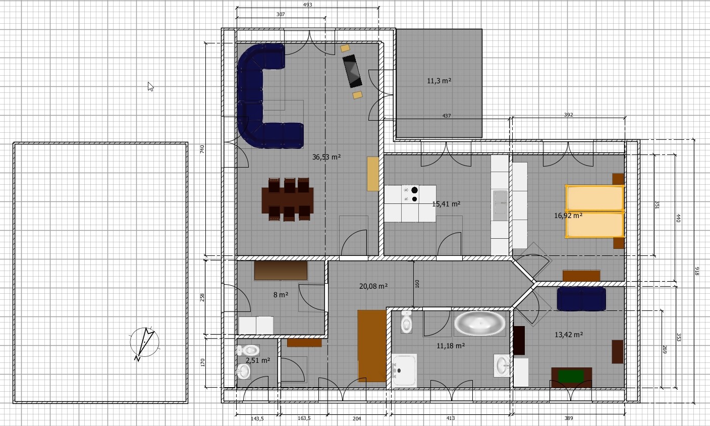Grundriss eines Hauses: Wohnzimmer mit Eckcouch, Esstisch, Küche, Bad, zwei Schlafzimmer.
