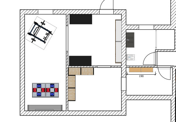2D-Grundriss eines Hauses mit Küche, Essbereich und Wohnzimmer, sichtbare Möbel und Türen.