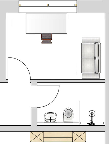 Grundriss eines Zimmers: Sofa rechts, Tisch in der Mitte, Tür links, Bad mit Waschbecken und Toilette.