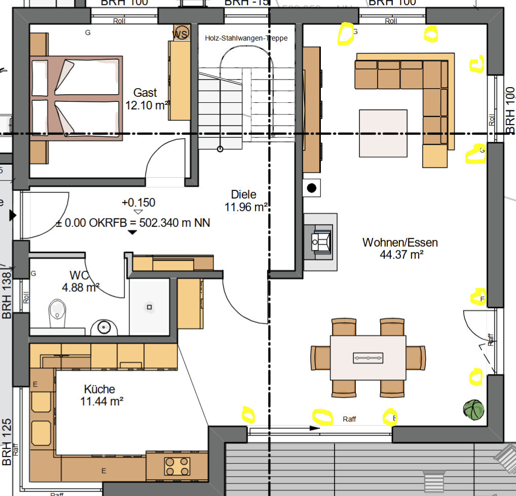 Grundriss eines Hauses: Küche, Diele, WC, Gästezimmer und offener Wohn-/Essbereich.