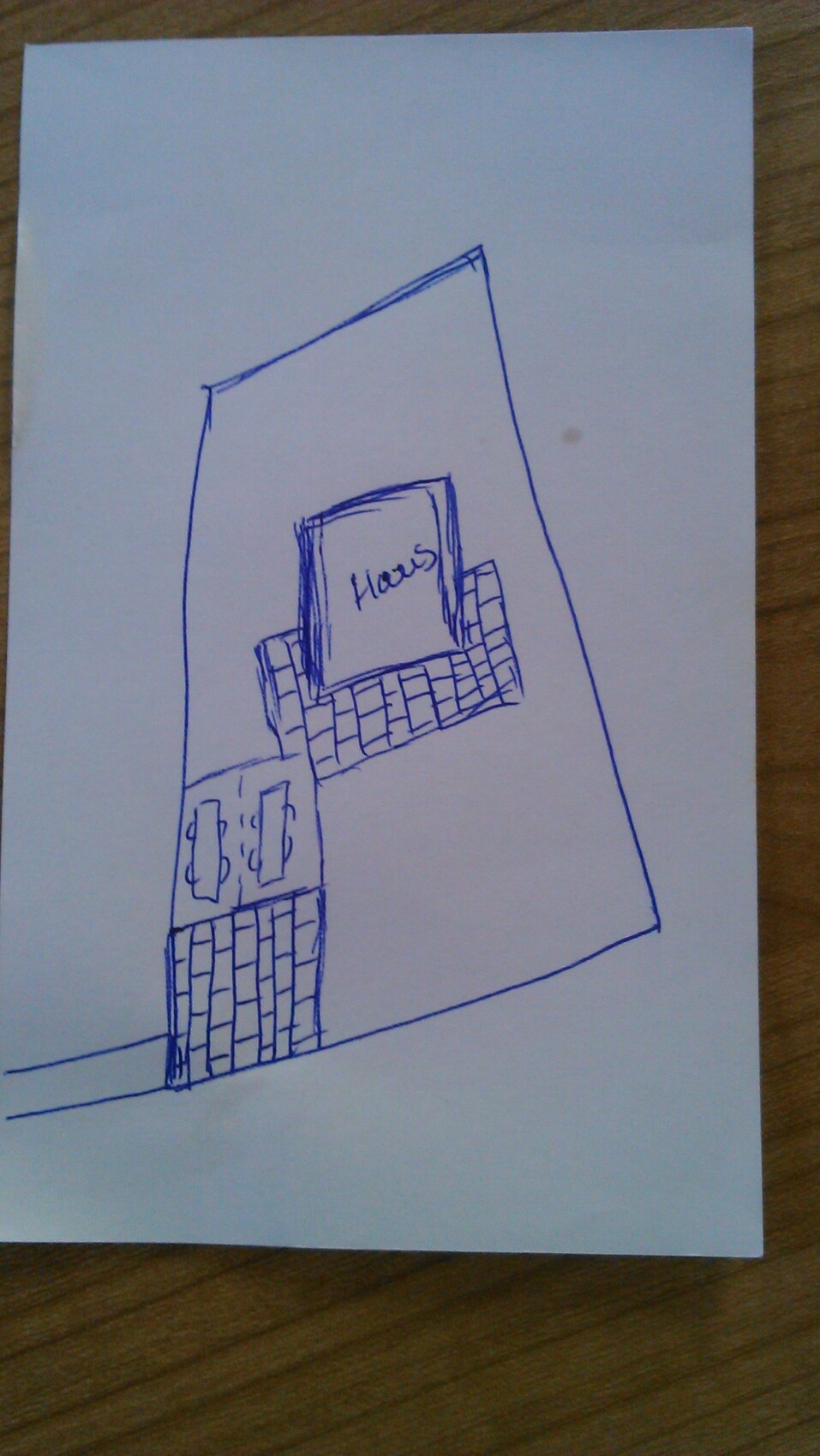 Handgezeichnete Skizze eines Hauses mit Ziegelmauer, Treppenstufen und dem Wort Haus.