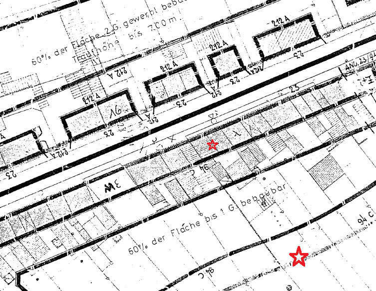 Schwarz-weiß Bauplan/Fertigungszeichnung mit Abmessungen; zwei rote Sterne markieren Punkte.