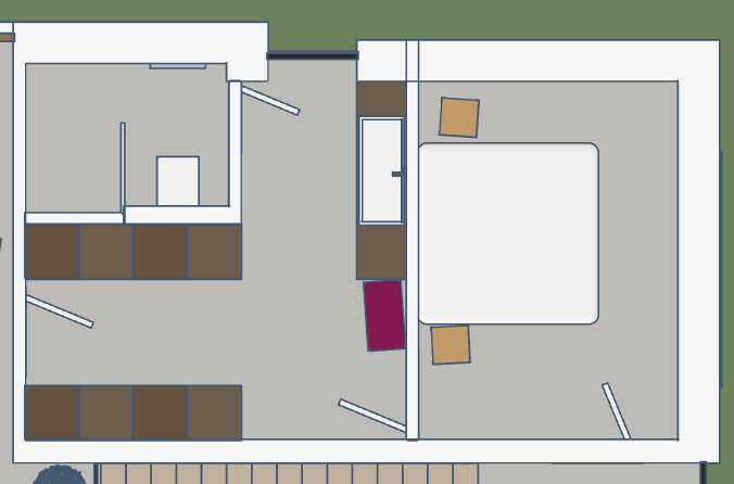 Grundriss eines Apartments: Schlafzimmer mit Bett und zwei Stühlen, Küche mit Schränken.