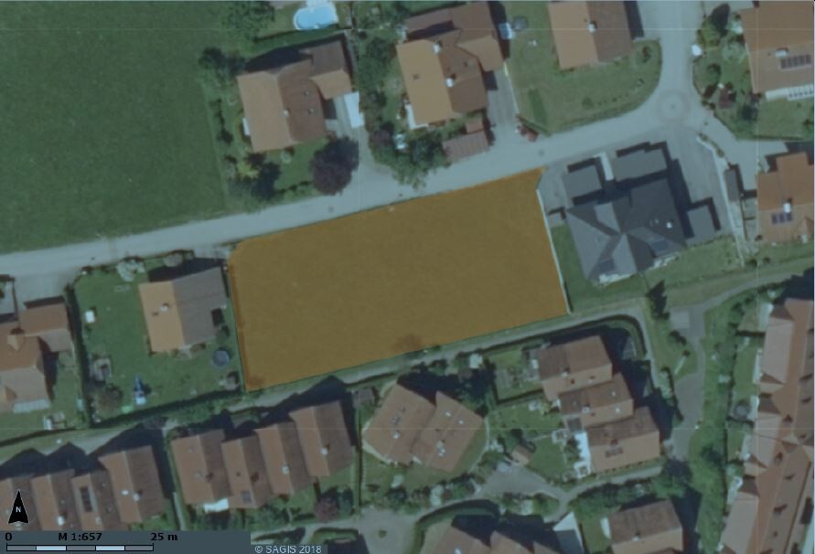 Luftbild eines Baugrundstücks in Wohnsiedlung zwischen Häusern.