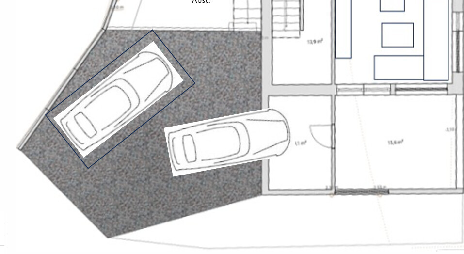 Grundriss: Garage mit zwei geparkten Autos neben Wohnräumen.