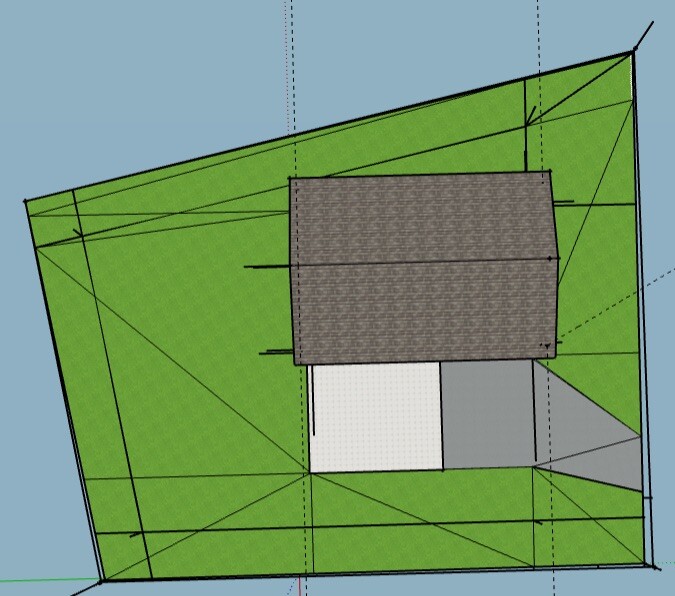 Draufsicht: grünes Grundstück mit dunkelgrauem Rechteckhaus und weißen/grauen Anbauten.