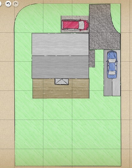 Vogelperspektive: Haus mit Holzterrasse, grauem Dach und zwei Autos auf Zufahrten.