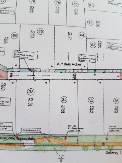 Lageplan mit nummerierten Parzellen und Beschriftungen wie Auf dem Acker und Spielbereich