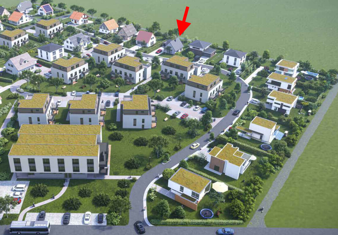 Luftbild einer geplanten Wohnsiedlung mit mehreren Häusern, Straßen und Grünflächen.