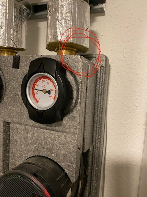 Heizungsanlage mit Temperaturmesser; markierter Bereich zeigt gelbe Dichtung an Rohrverbindung.