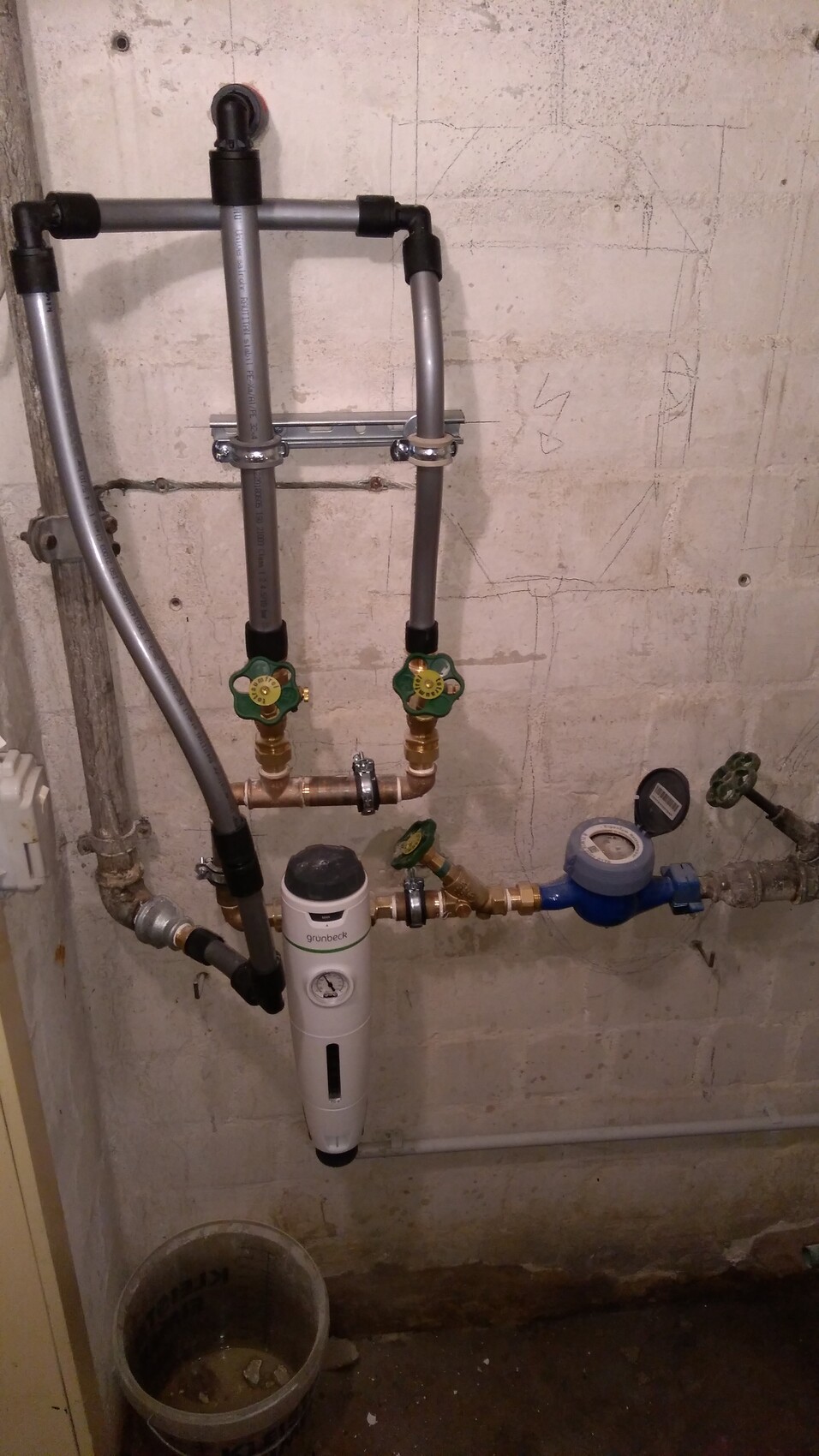 Keller-Sanitärinstallation: Rohre, Grunbeck-Filter, Wasserzähler, grüne Absperrventile