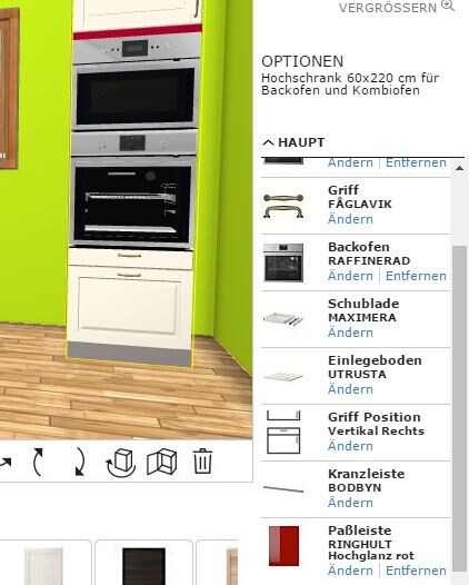 Helle Küche mit integriertem doppelten Backofen in weißem Schrank vor grünen Wänden und Holzboden.