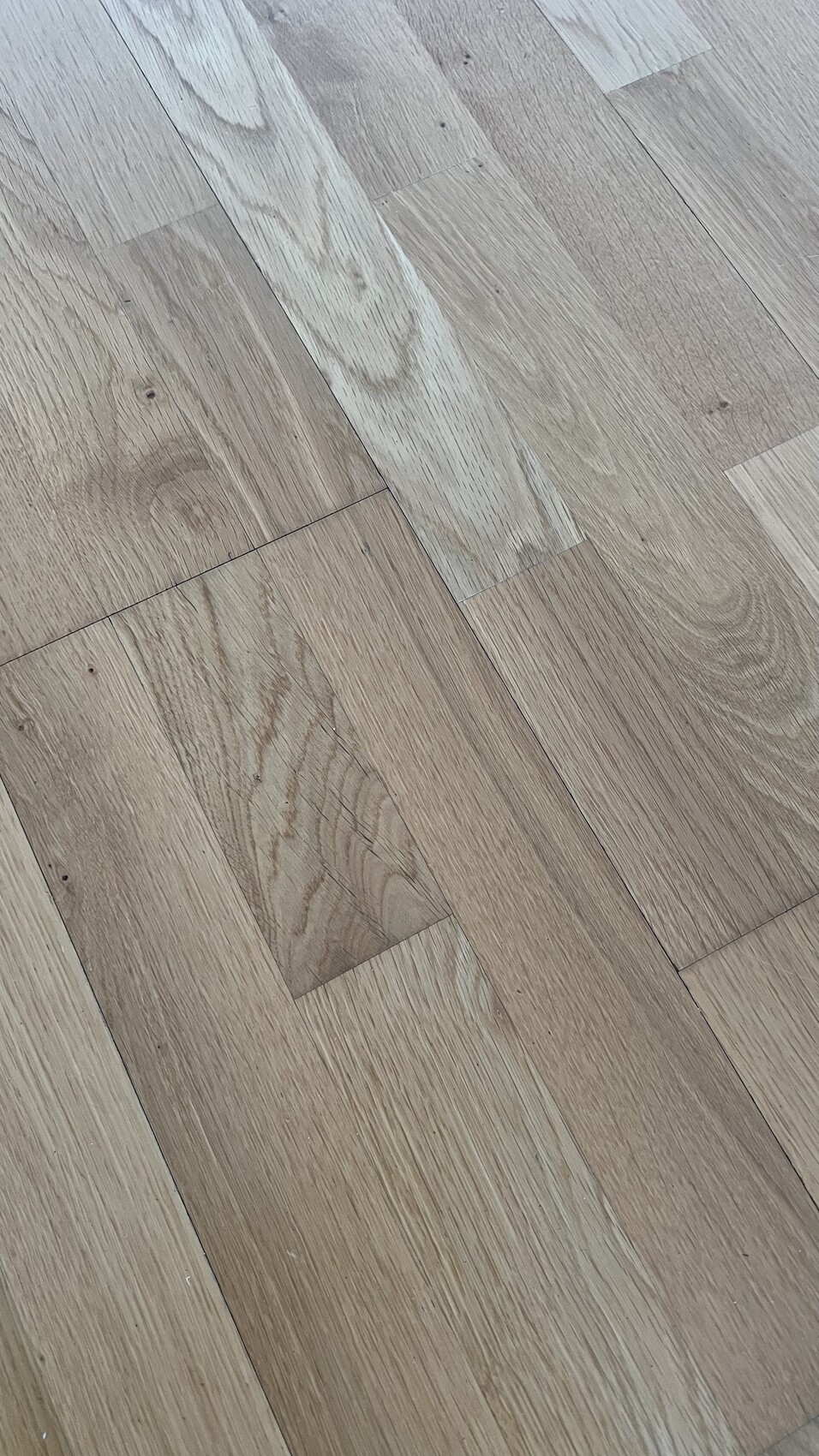 Holzfußboden mit hellbraunen Holzdielen und sichtbarer Maserung.