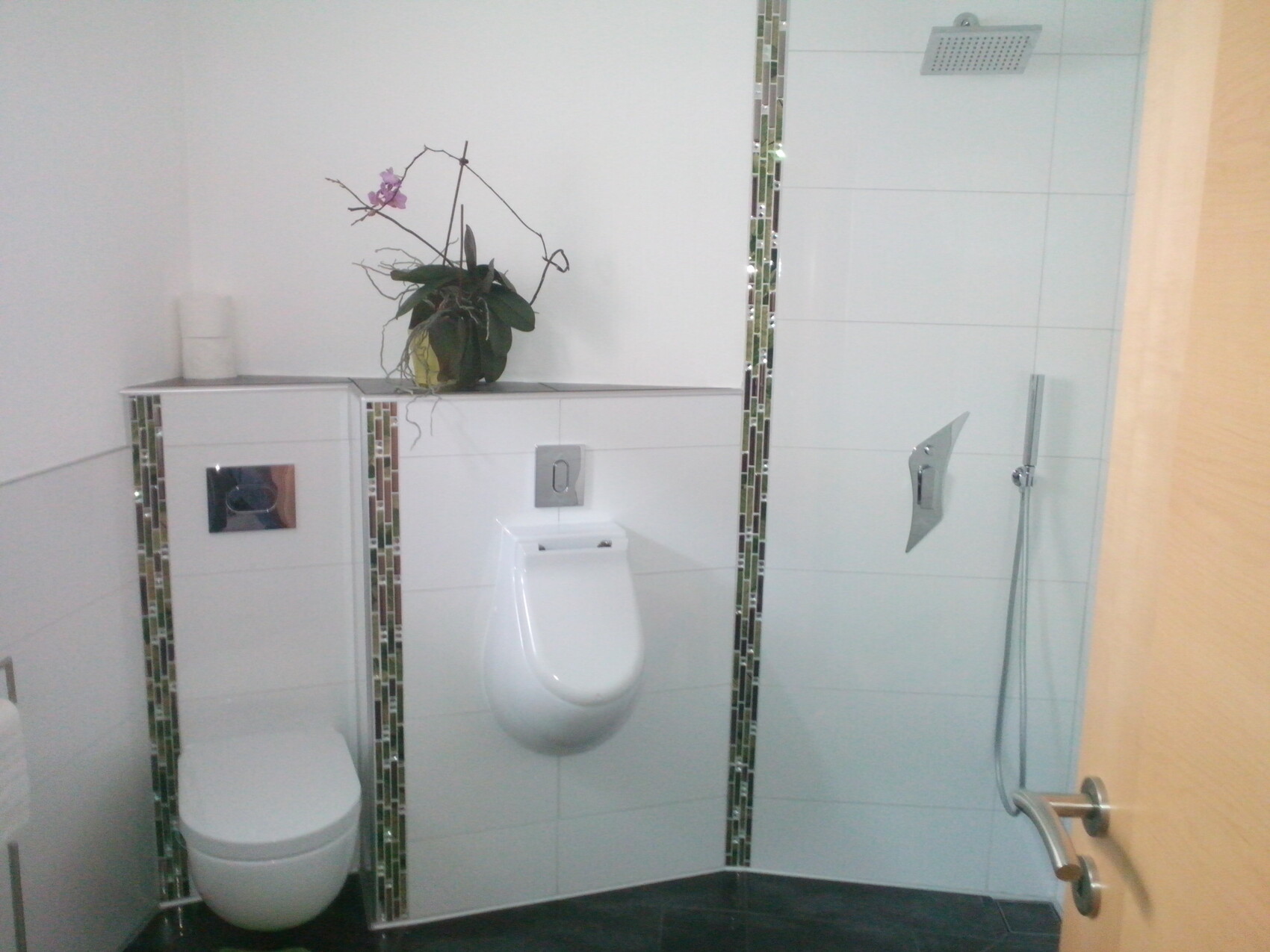 helles-badezimmer-mit-weiss-fliesen-dusche-toilette.jpg