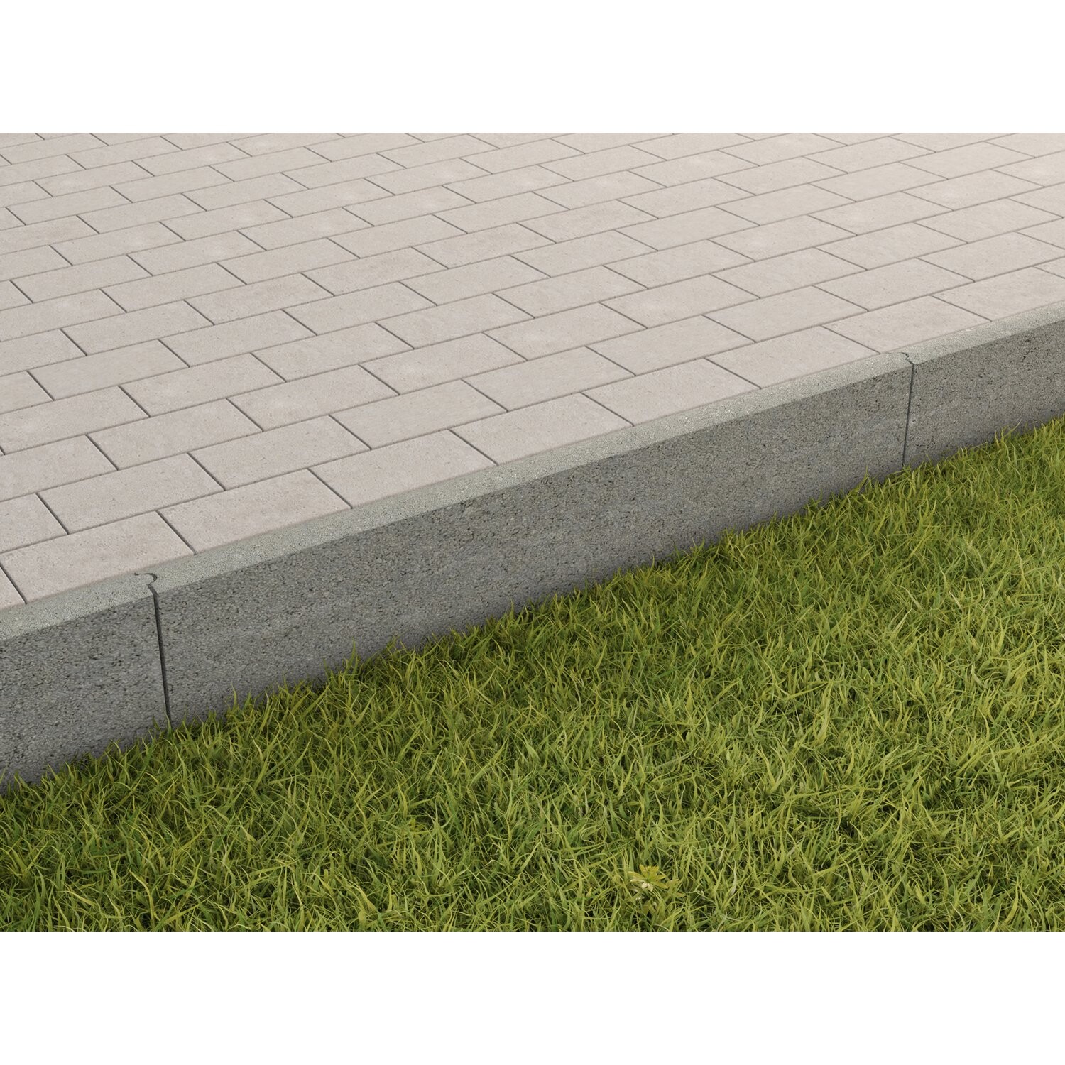 Gepflasterte hellgraue Pflastersteine mit Grasstreifen neben einem Betonbordstein.
