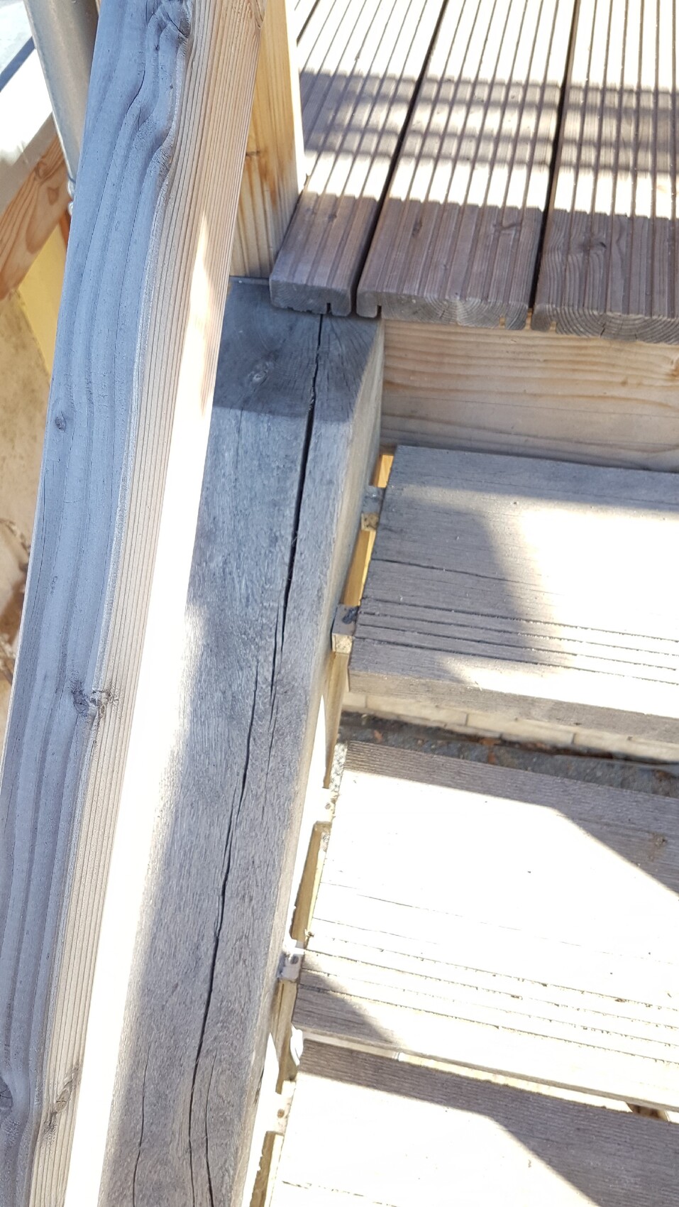 Holztreppe und Deck mit großen Rissen im Balken bei Bauarbeiten