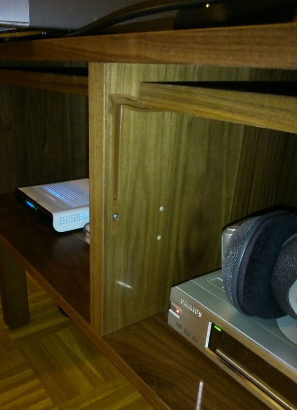 Holzregal mit Audioanlage und Kopfhörern im Wohnzimmer