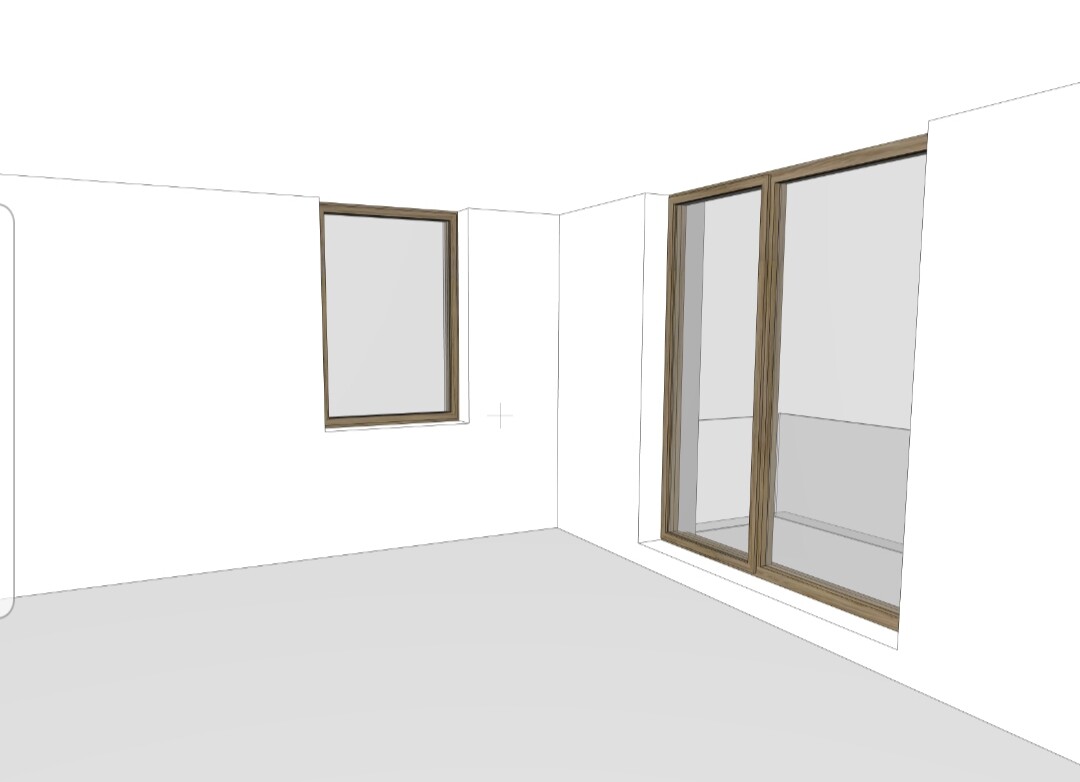 Leerer Innenraum mit grauem Boden; zwei Fenster mit Holzrahmen, kleines links, großes rechts.