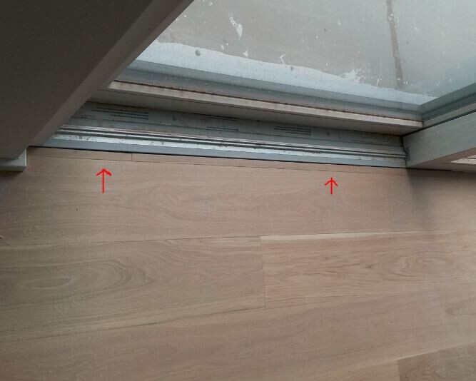 Laminatboden neben Glas-Schiebetür mit Bodenschiene