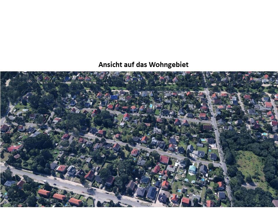 Luftbild eines Wohngebiets mit vielen Häusern, Straßen und Bäumen.