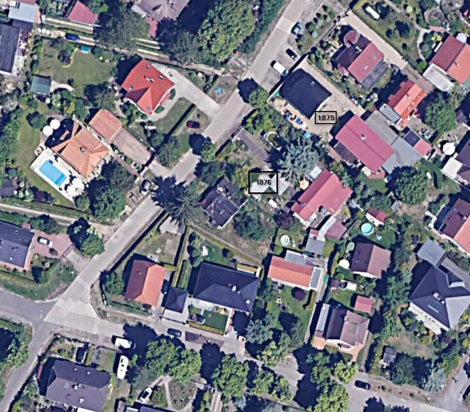 Luftaufnahme eines Wohnviertels mit Dächern, Straßen und Bäumen; Häuser 1875 und 1876 markiert.