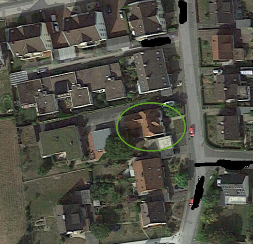Luftbild eines Wohnviertels; ein Haus mit orangefarbenem Dach ist im grünen Kreis hervorgehoben