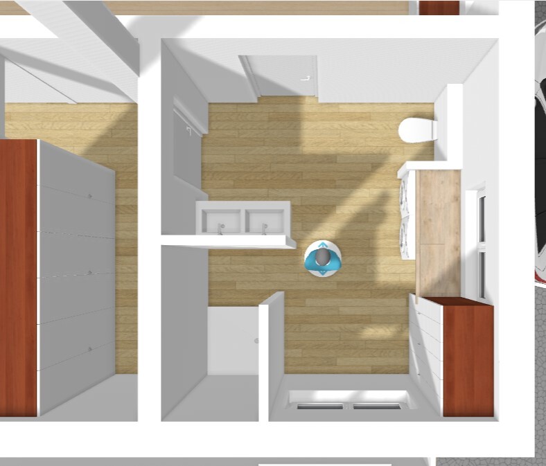 Grundriss eines kleinen Apartments von oben: Küche, Bad, Wohnbereich, Person am Tisch.