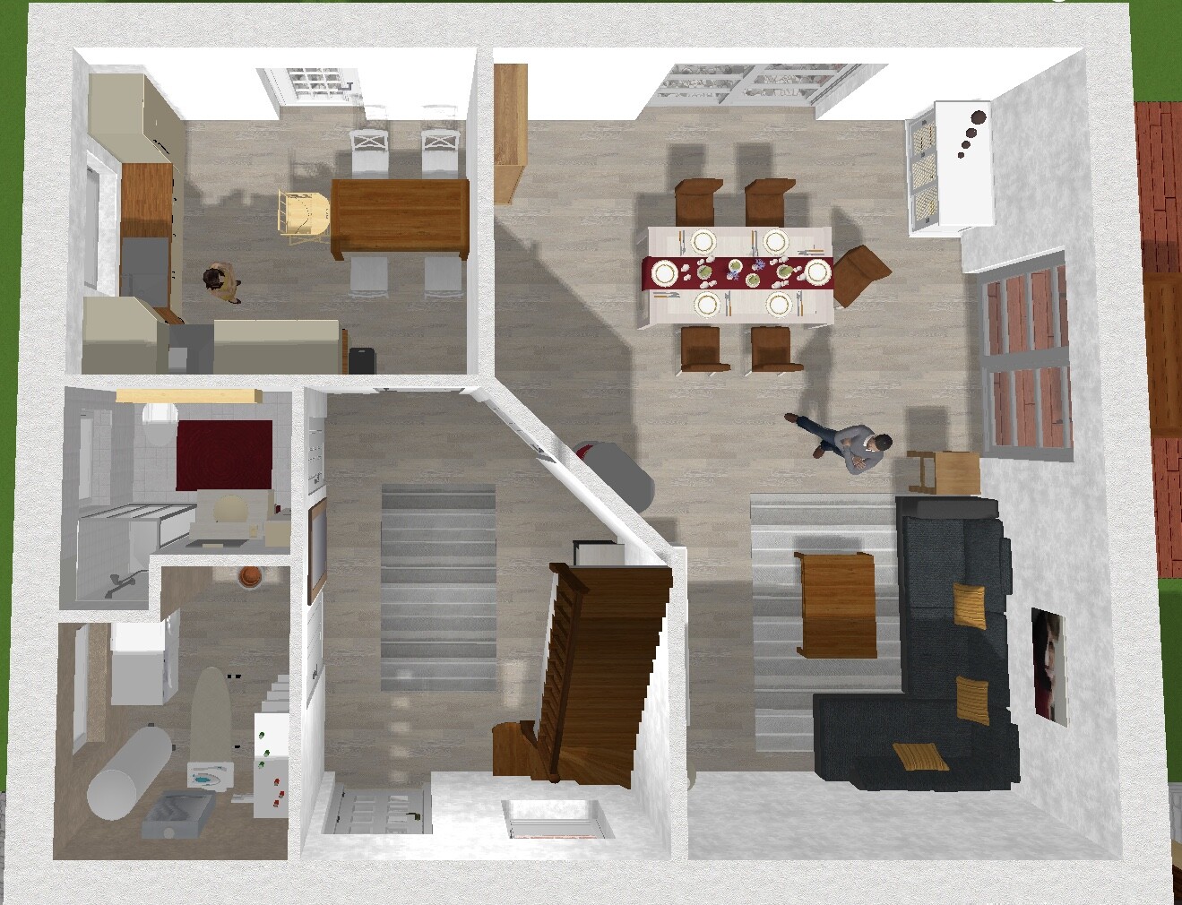 Grundriss eines Hauses: Küche links mit Person, Essbereich oben, Wohnzimmer rechts, Treppenhaus Mitte