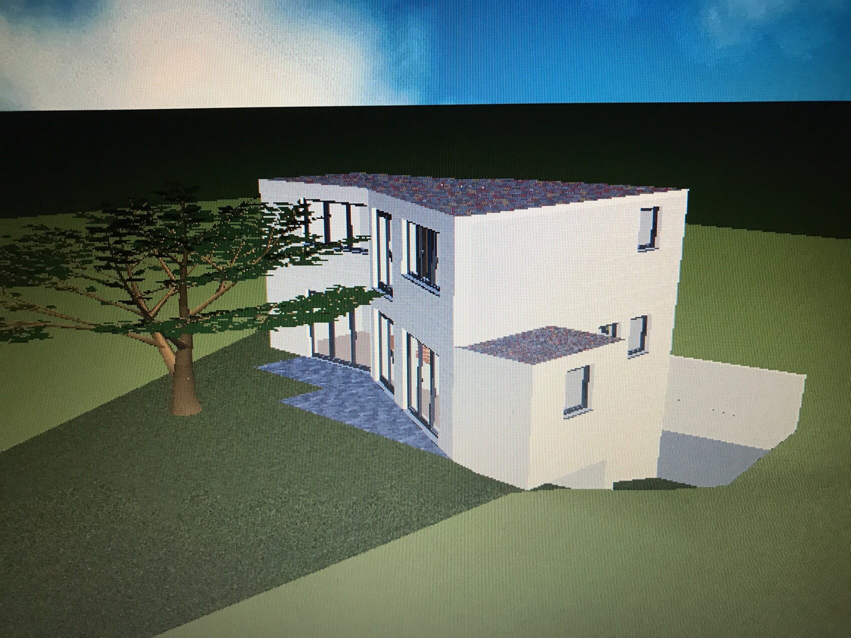 Moderne weiße zweistöckige Villa mit Flachdach, Glasfronten und Baum im Garten.
