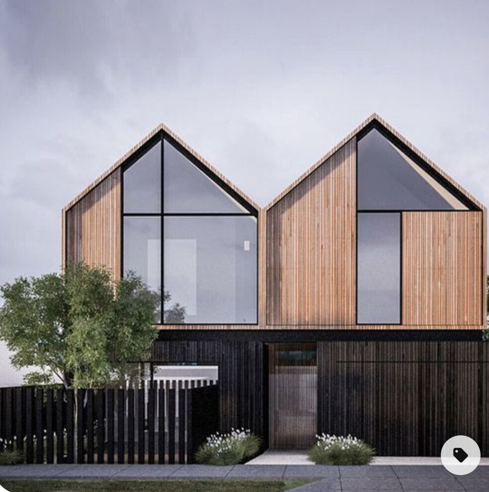 Modernes zweistöckiges Haus mit Holzverkleidung, großen Glasfronten und Giebel-Dächern; Gartenzaun.