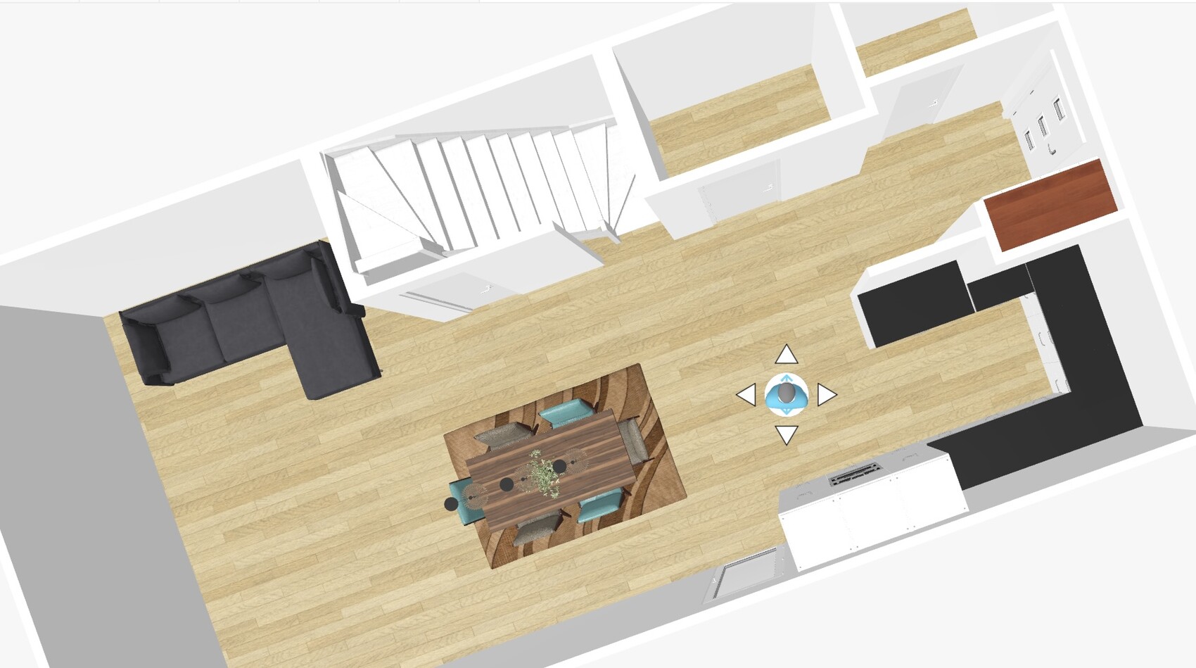 Offenes Wohnküchen-Layout mit Esstisch, Ecksofa, Treppe und Küchenzeile.