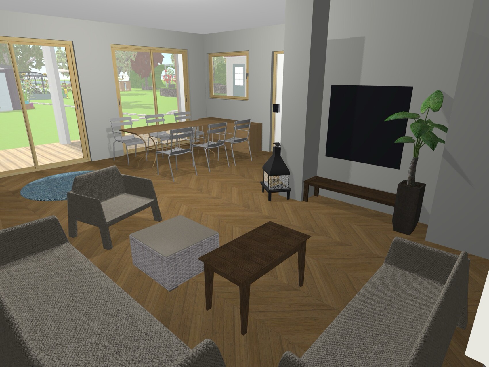 Wohnzimmer mit Esstisch, Sofa, Sessel, Kamin, TV, Pflanze und Blick zum Garten.