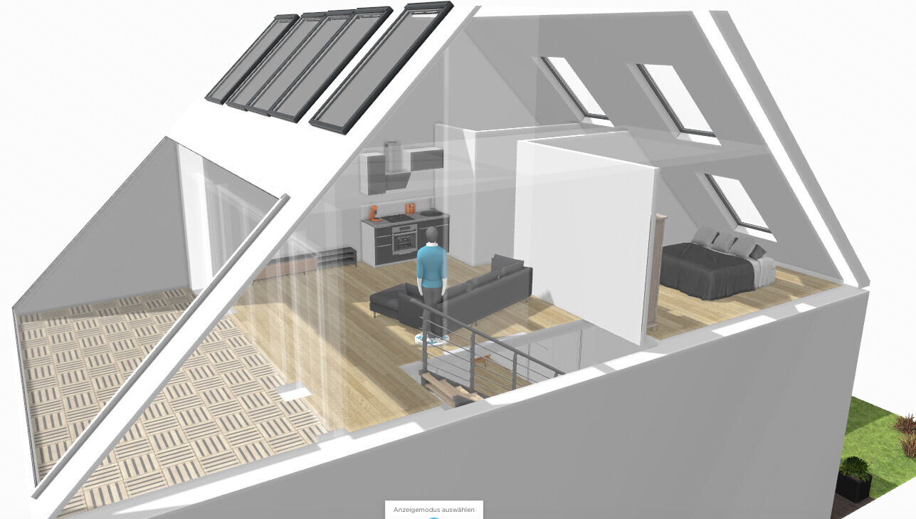 Eine Person steht im offenen Dachgeschoss mit Küche, Wohnzimmer, Schlafzimmer und Treppe.