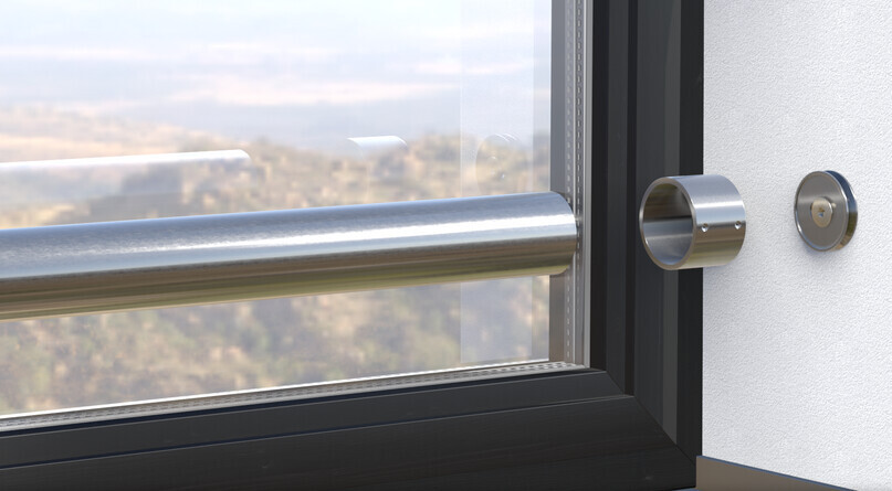 Nahaufnahme eines Fensterrahmens mit Edelstahlstange und rundem Türzylinder.