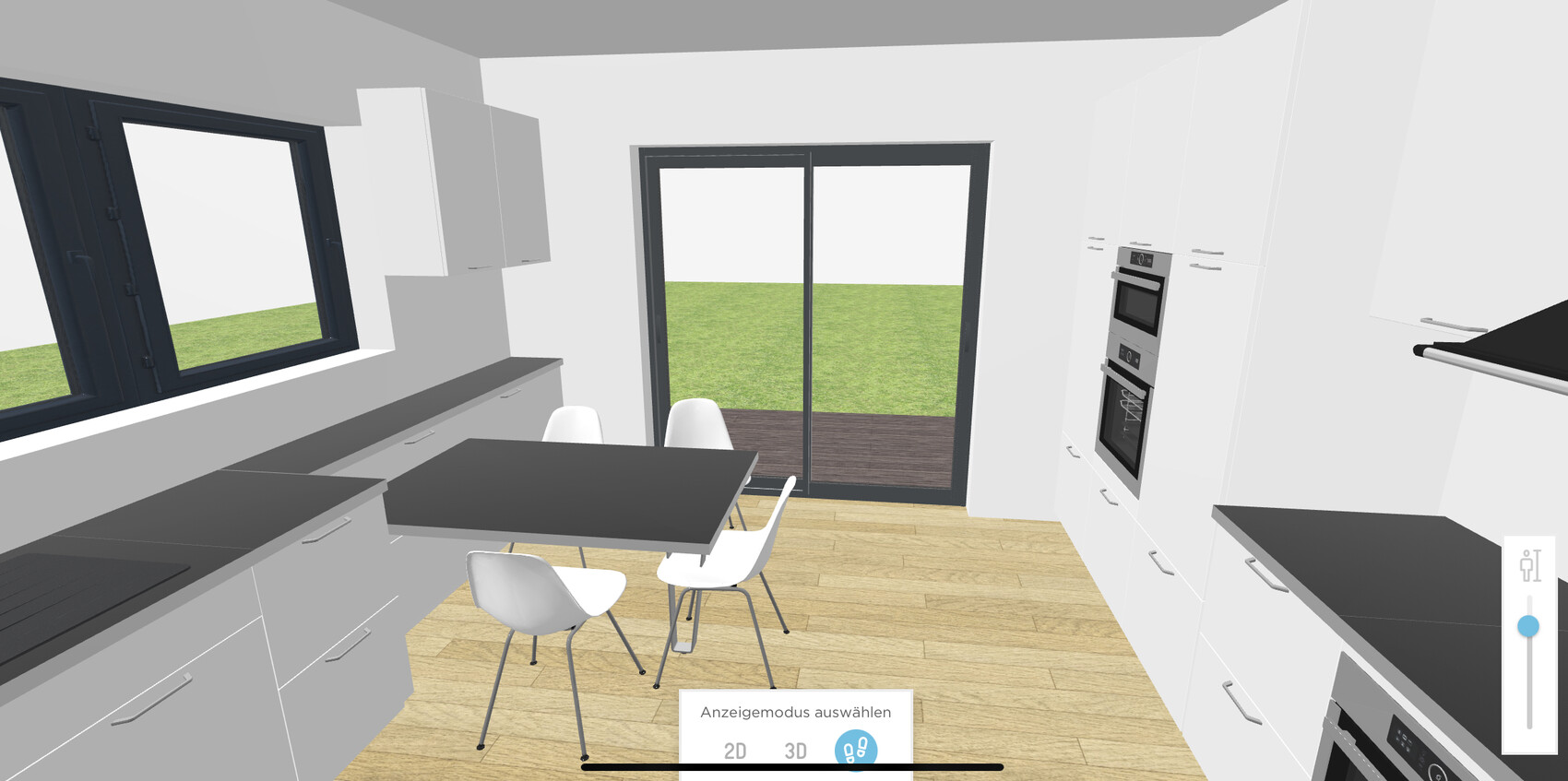 Moderne Küche mit weißen Schränken, dunklen Arbeitsplatten, Tisch und Stühlen, Glastür nach draußen.
